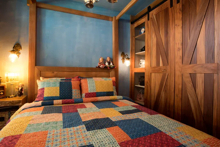 All the wooden features in this room, including the window frame, wardrobe and side tables, are customised for the space. 