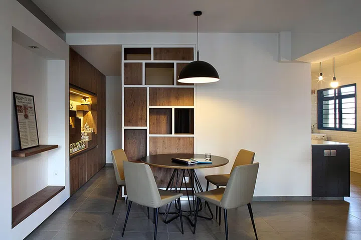 A twist of modern, industrial and scandinavian interior design styles in this HDB flat with a black, modern dining table with 4 cushioned grey dining chairs. Interior design by The Scientist.