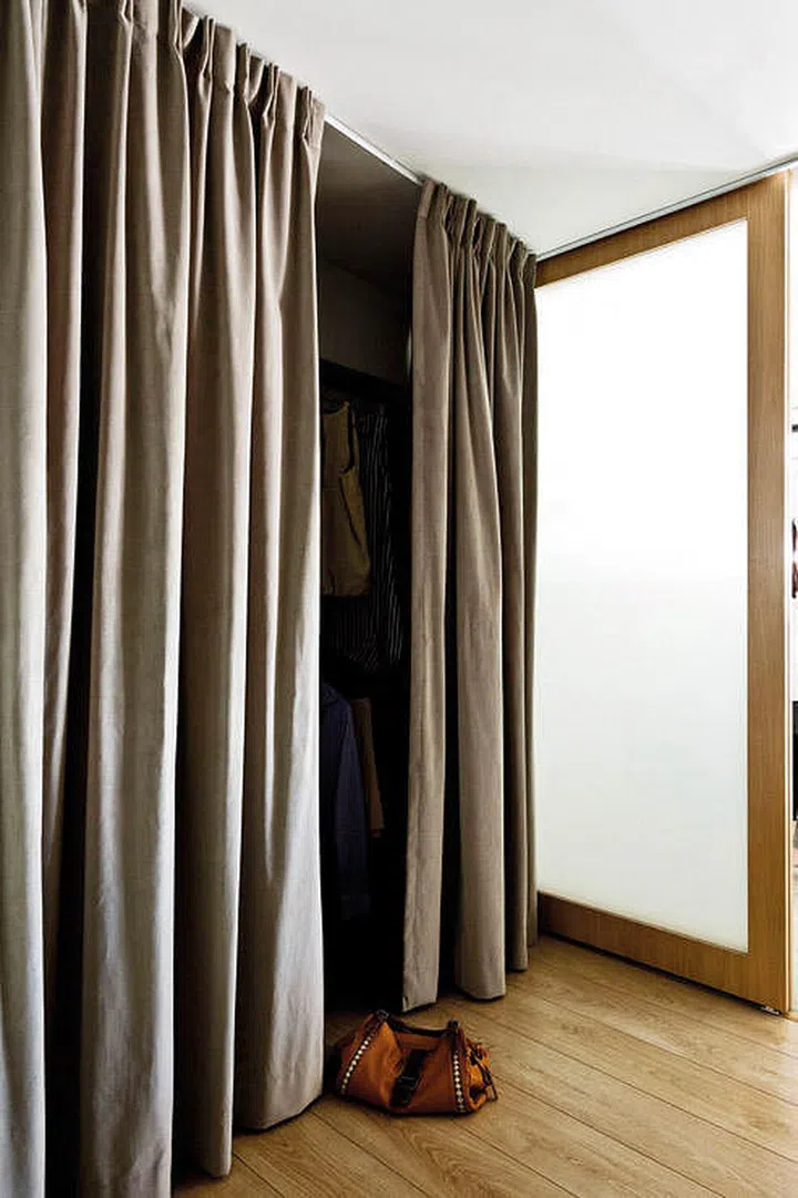 The walk-in wardrobe has a curtain 'door' to soften the look in the master bedroom. It can also be drawn over the room's frosted glass door to keep out external light or close the bedroom from view.