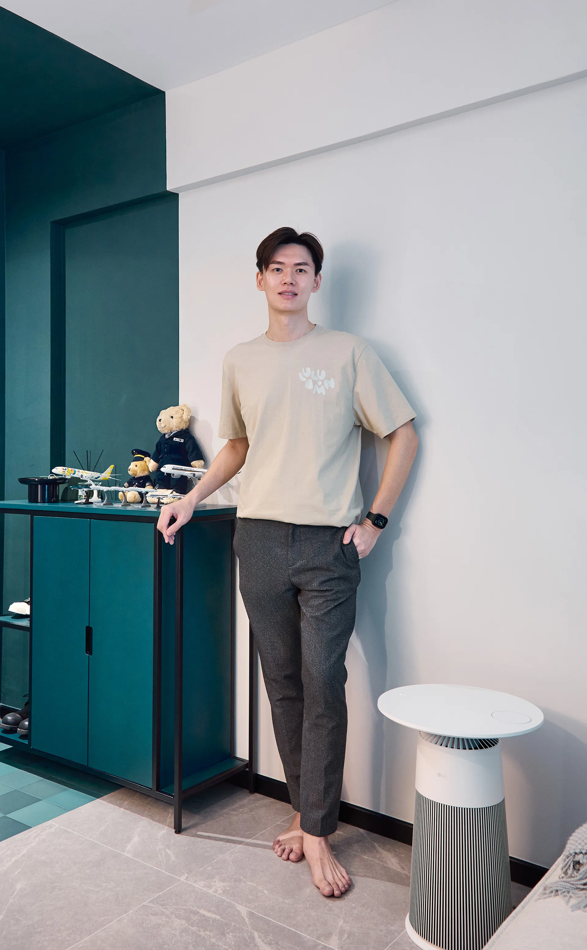 Duncan Chew standing in his thoughtfully designed flat, a blend of personal memories and minimalist style.