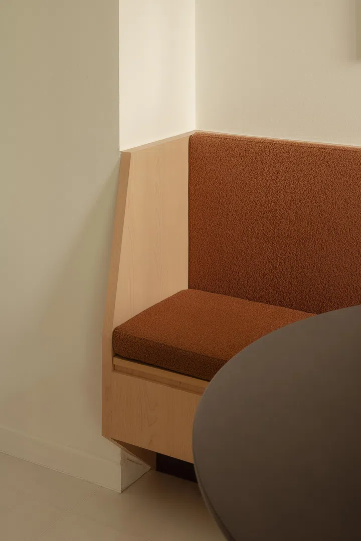 Simple detailing and warm textures ground the built-in banquette in timeless functionality.