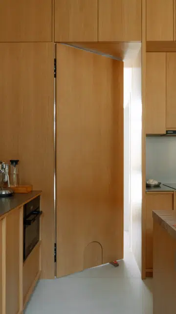 Even the concealed kitchen door incorporates a discreet cat flap, allowing Yquem and Lafite to roam freely throughout the home.