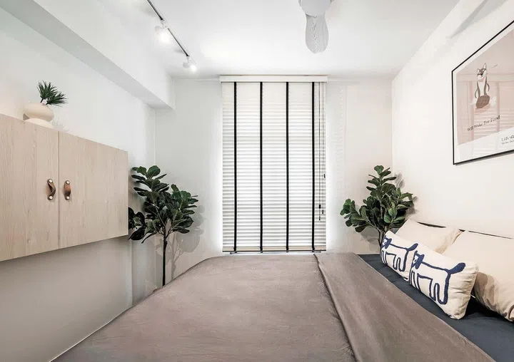 The master bedroom with a double bed and hidden TV cabinet.