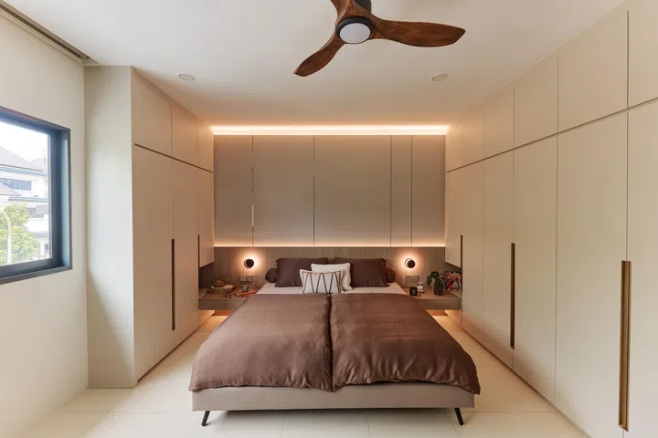 The master bedroom continues the home’s restrained palette, creating a calm retreat that looks out towards the garden and the birds that first convinced the couple to stay.