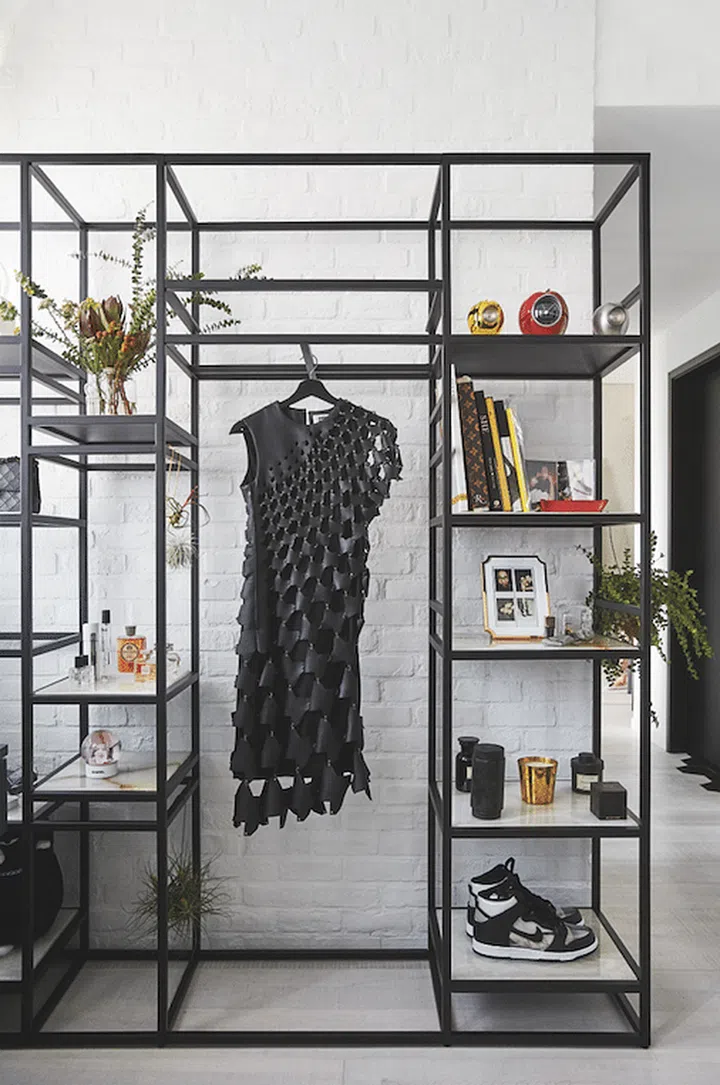 The display shelves in the master bedroom showcase some of the couple’s favourite items, including their collection of candles, fragrances, photographs and clothing.