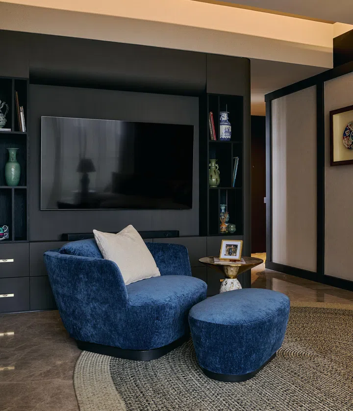 Accent seating in muted blue adds contrast while maintaining the refined, modern Oriental aesthetic.
