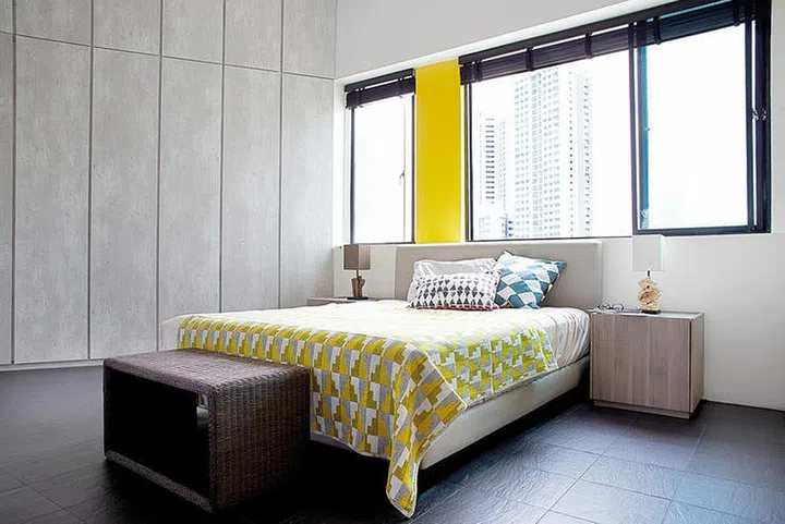 The sleeping area, originally two bedrooms, can be screened off with curtains for privacy. Blanket and cushions from The Design Store.