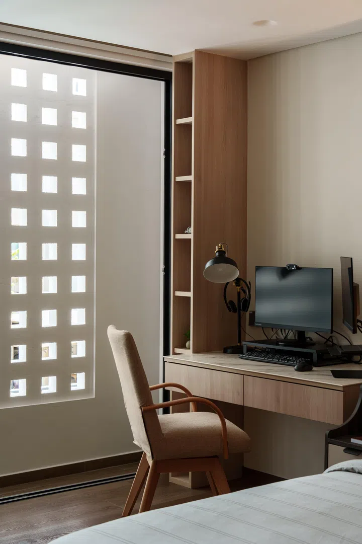 From the master suite, the breeze block screen filters light into the study corner without fully exposing the room.