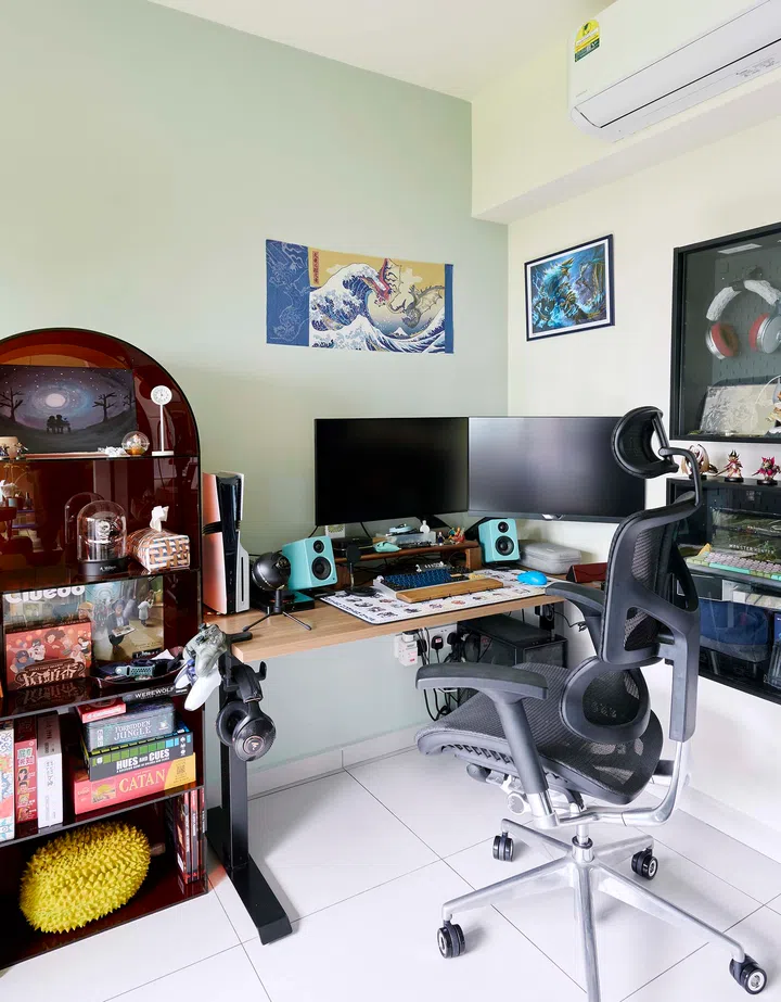Their gaming setup and bookshelf, blending functionality with personal flair.

