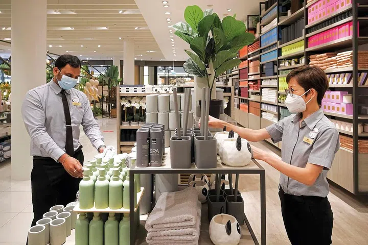 Harvey Norman furniture specialist Srinivasan Sargunavelu, from India, and sales executive Mint Cao, from Vietnam, are both S Pass holders seen here at the Millenia Walk on Feb 24, 2022.