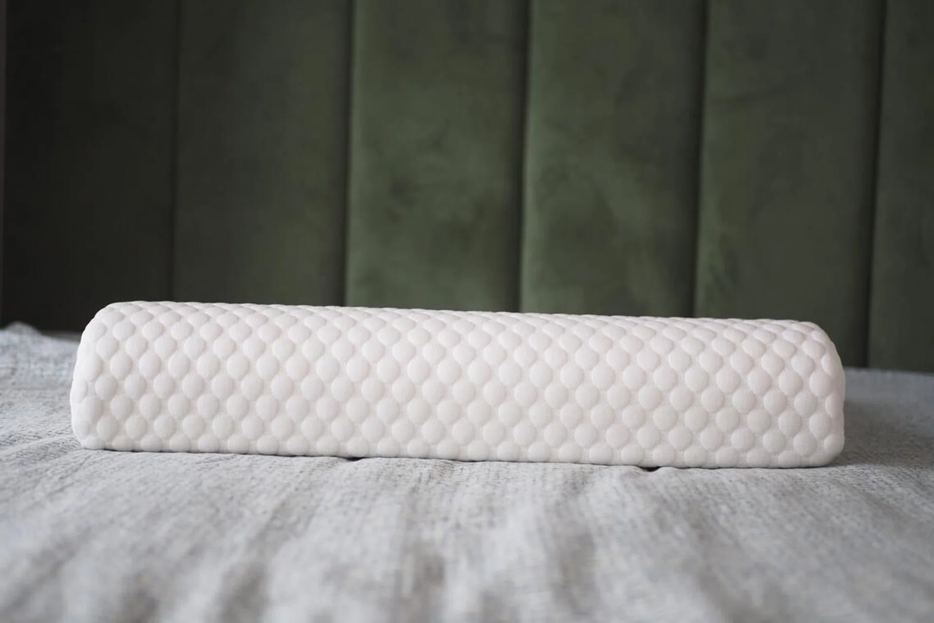 Orthopedic pillow on a bed.