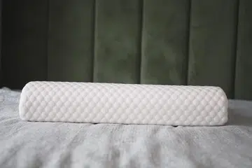Orthopedic pillow on a bed.