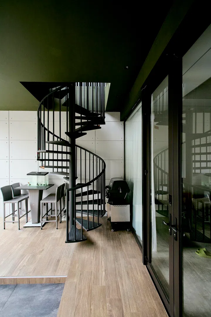 The spiral staircase at the car porch provides direct access to the second floor, allowing the upper level to function independently as a future rental space without passing through the main home.