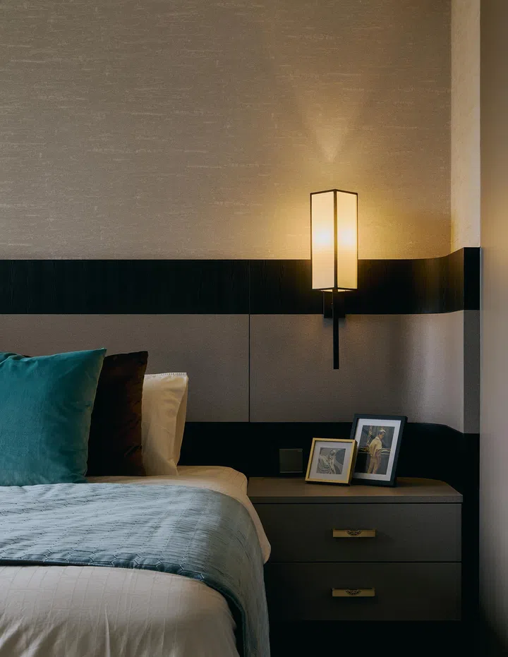 Elegant Oriental wall lamps and soft furnishings add layers of warmth and sophistication to the master bedroom.