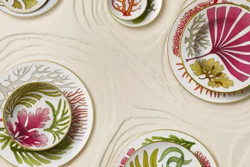 Hermès’ Natures Marines tableware collection launches in Singapore on 1 August 2026. Designed by British illustrator Katie Scott, the collection’s 34 pieces feature a marine garden inspired by nineteenth-century English botanical illustrations and the marine flora of the Welsh coastline.