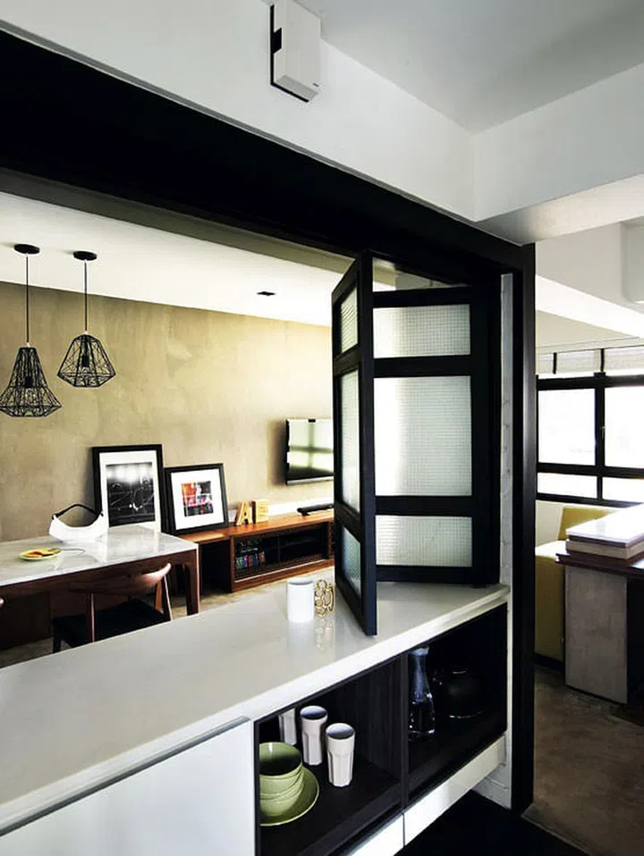 The folding screen along the breakfast counter helps to keep out cooking smells and opens up the space when needed. Mug on counter from The Good Things. Interior design by Project File.