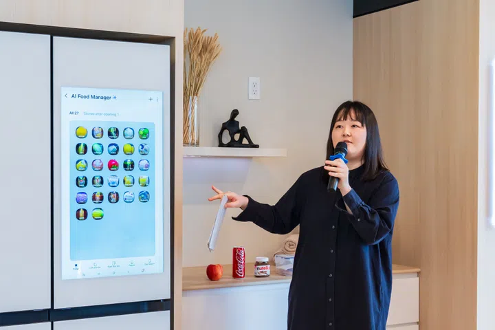 A Samsung product specialist demonstrating the capabilities of the enhanced AI Vision on the Bespoke AI Refrigerator Family Hub.