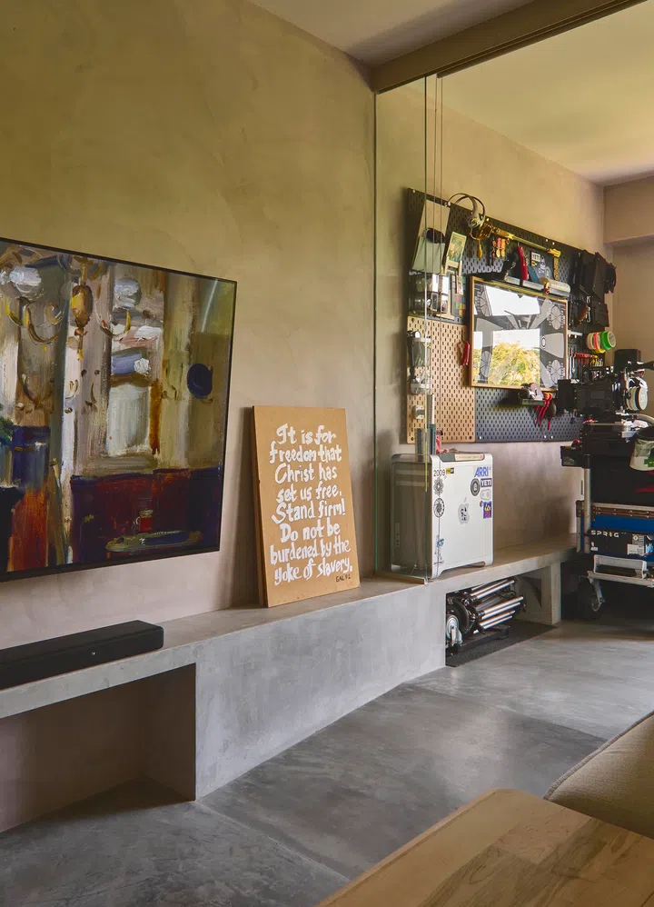The concrete television console from the living area continues into the dining room and forms a low ledge where he can place smaller items.