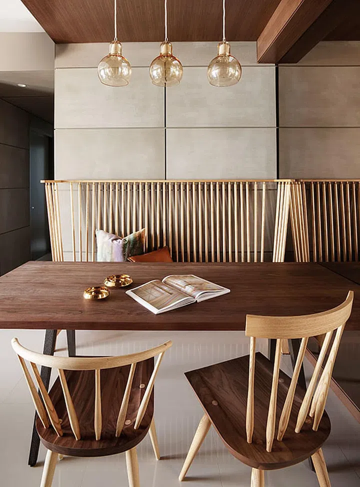 The handsome Matthew Hilton walnut dining table and accompanying Windsor chairs are matched with Studioilse's two-seater high-back bench padded with a customised warm honey brown leather seat.