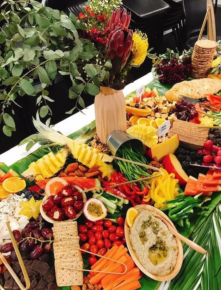 Decorate your grazing table or board with vases of green foliage and leaves for a lush, full look. Image by Kiss My Pans.