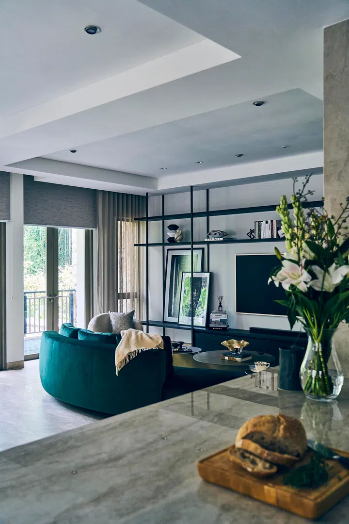 Bespoke open shelving frames the living area, providing both display and architectural definition.