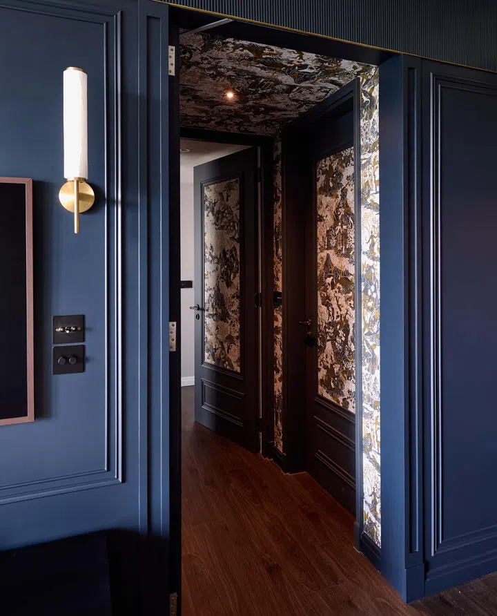 A discreet door leads to a hidden corridor, adding an element of surprise to the home’s design.