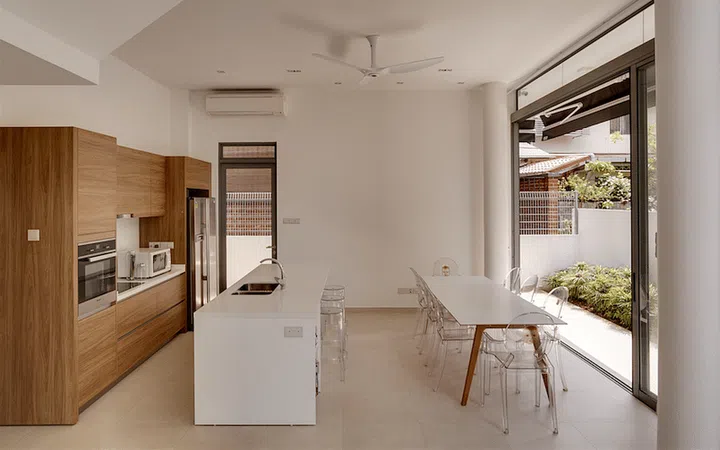 The dining area sits alongside the dry kitchen, which has an island counter that offers additional seating when the family entertains guests.