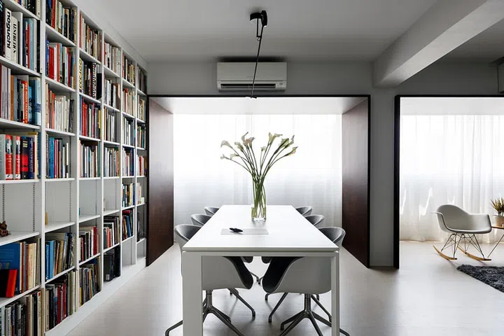 The homeowner, an architect's floor to ceiling bookshelf, filled with books on art, architecture and landscaping.