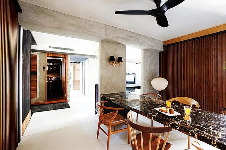 As homeowner, Woon, likes symmetry, he positioned the long table down the middle of the dining area. The designer lamps in the common spaces come in a mix of styles, from sculptural to ornate.