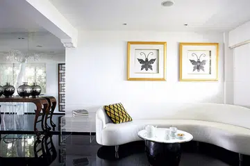 This single, long curved sofa is less space-hungry than the usual two-piece arrangement.