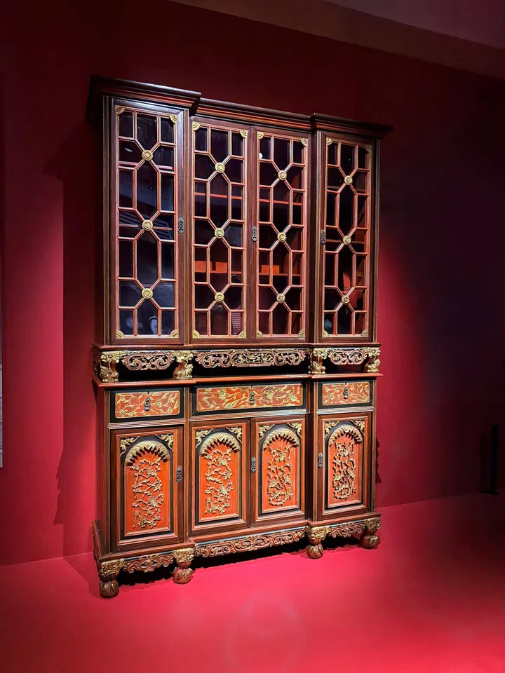 A “red and gold” gilded (means: covered with a thin layer of gold) cabinet made from namwood (means: highly prized Chinese Imperial wood) and red lacquer.