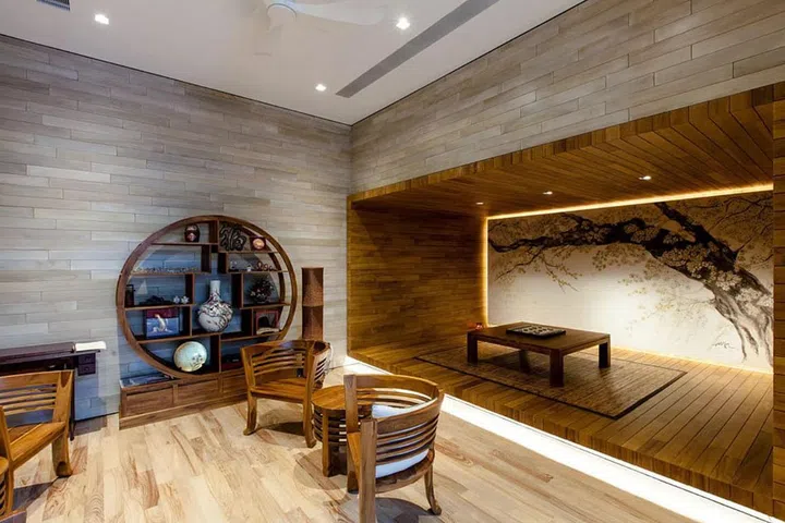 A painting of a sakura tree, done by the architect Aamer Taher, fills a wall in the basement, which is designed for communal and leisure activities.