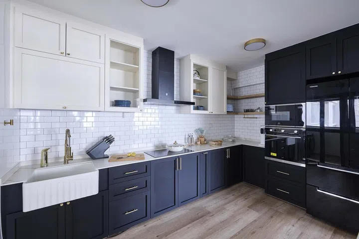 Shaker-style cabinets complete with a farmhouse sink in this 32-year-old man's 5-room HDB flat in Tampines Ave 8.