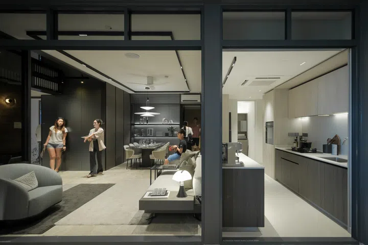 Potential buyers of The Continuum condominium looking at a model and having discussions at the show flat at Rose Lane, April 29, 2023.