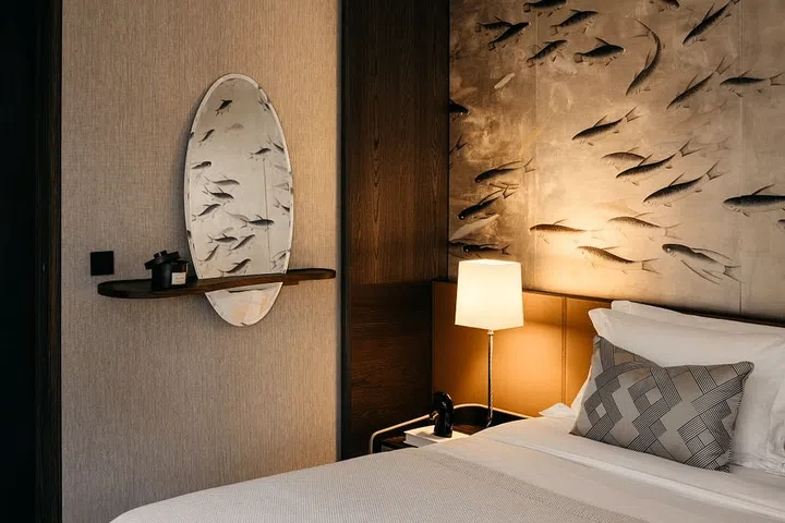 The Bienvenue mirror from Ligne Roset, featuring an oval shape and a curving walnut shelf, is available from Grafunkt. (Photo: Massoneong)