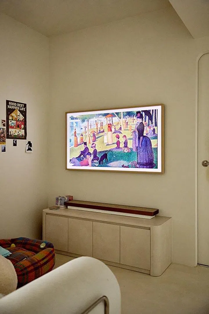 The Samsung Frame TV blends into the wall as art when idle, a practical choice that keeps the living room visually calm.