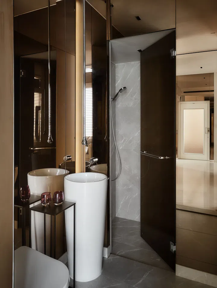 The hidden powder room on the first storey is elegantly designed with mirrored finishes all around that give it a kaleidoscopic effect.