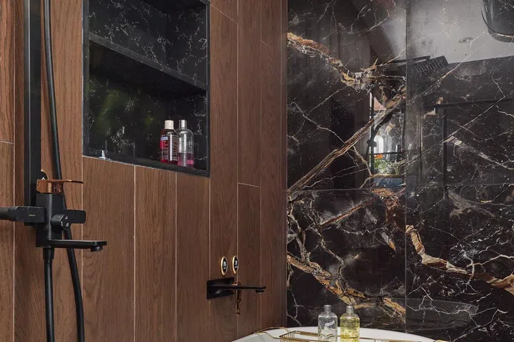 A freestanding bath tub sits in the en suire bathroom in a HDB Executive Maisonette in Pasir Ris.
