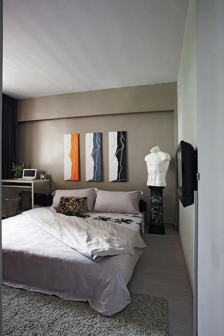 The fibre glass human bust and three-panel painting of the human silhouette make John’s bedroom resemble a chic art gallery in interior designer John Susanto's 3-room resale HDB flat.