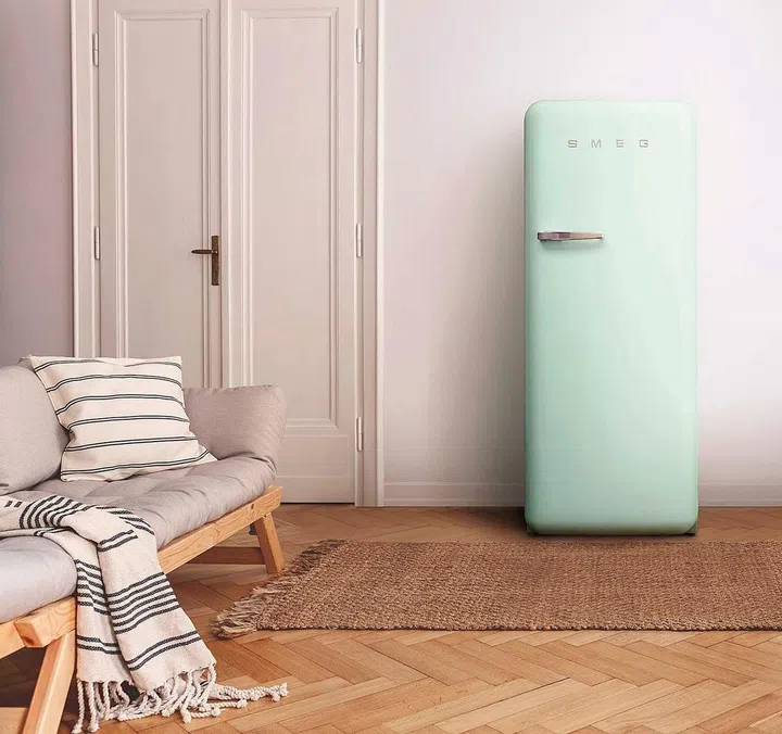 Armchair on rug next to bench with plants in white loft interior with wooden sofa. Real photo; Shutterstock ID 1182182920; Purchase Order: Smeg Spa; Job: Lifestyle; Client/Licensee: Bertelli / Cristina