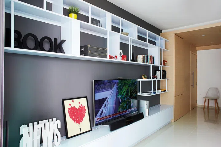 An open shelving system adds contrast to the concealed storage space.