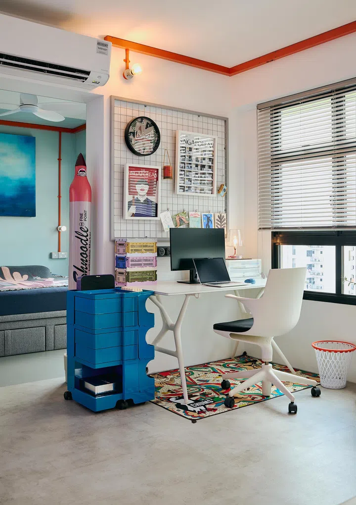 The workstation is located within the living room, benefiting from the spacious layout and natural lighting.