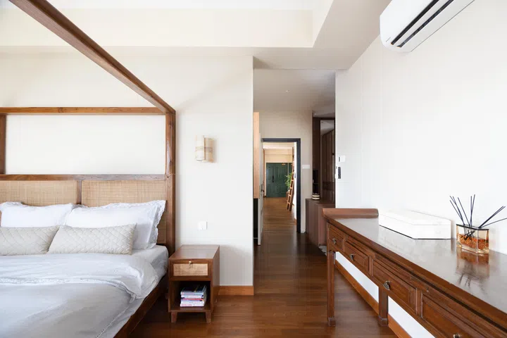 The master bedroom features a custom-built teak canopy bedframe and other teak furniture.