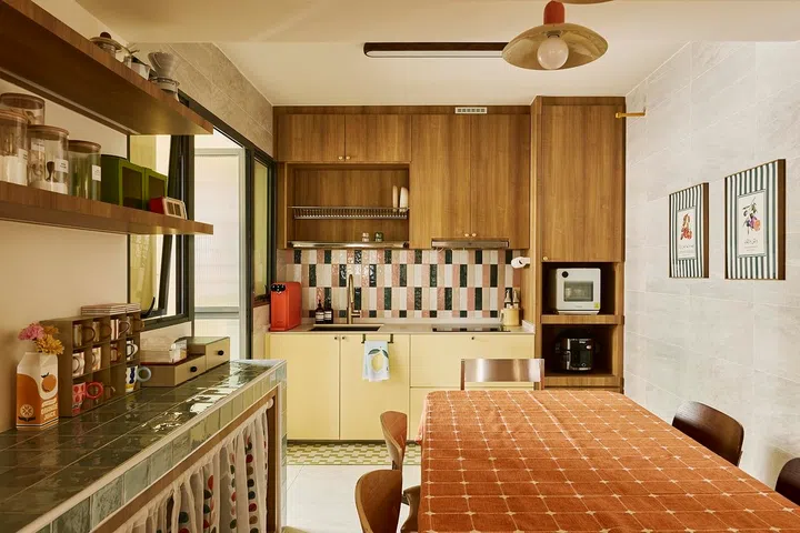 Cheerful butter-yellow cabinetry, handcrafted-look tiles and warm timber create the welcoming kitchen Najiha and Iqbal had imagined from the start.