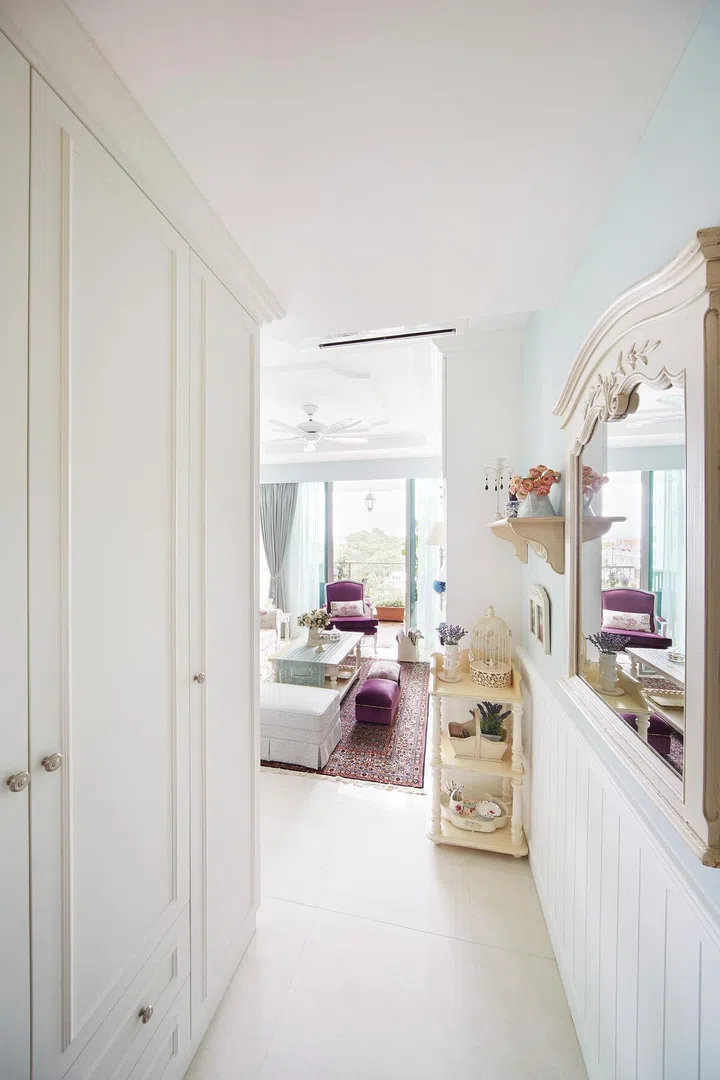 The pastel tone goes well with the floral motifs on the upholstery and carvings on the mirror, a decorative detail the homeowners requested. 