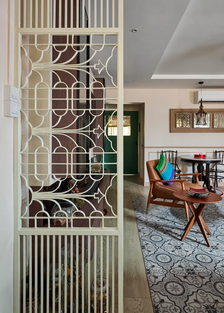The cream-painted iron grille from Ms Mush’s childhood home, now a sentimental centrepiece at the entrance.