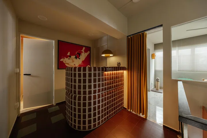 Unused space at the top of the staircase was converted into a moody home bar.