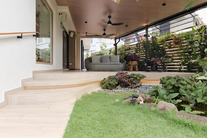 Softly curved steps and concealed lighting were introduced to preserve uninterrupted views from the new picture window while creating a gentler transition into the garden.