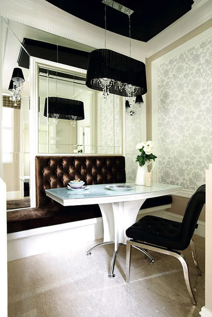 Designed to mimic a VIP table at an upscale restaurant, this dining area features darker, more sensual shades and textures. Contrasted with a contemporary dining table and chair, this space gives off an effortlessly eclectic charm as well!