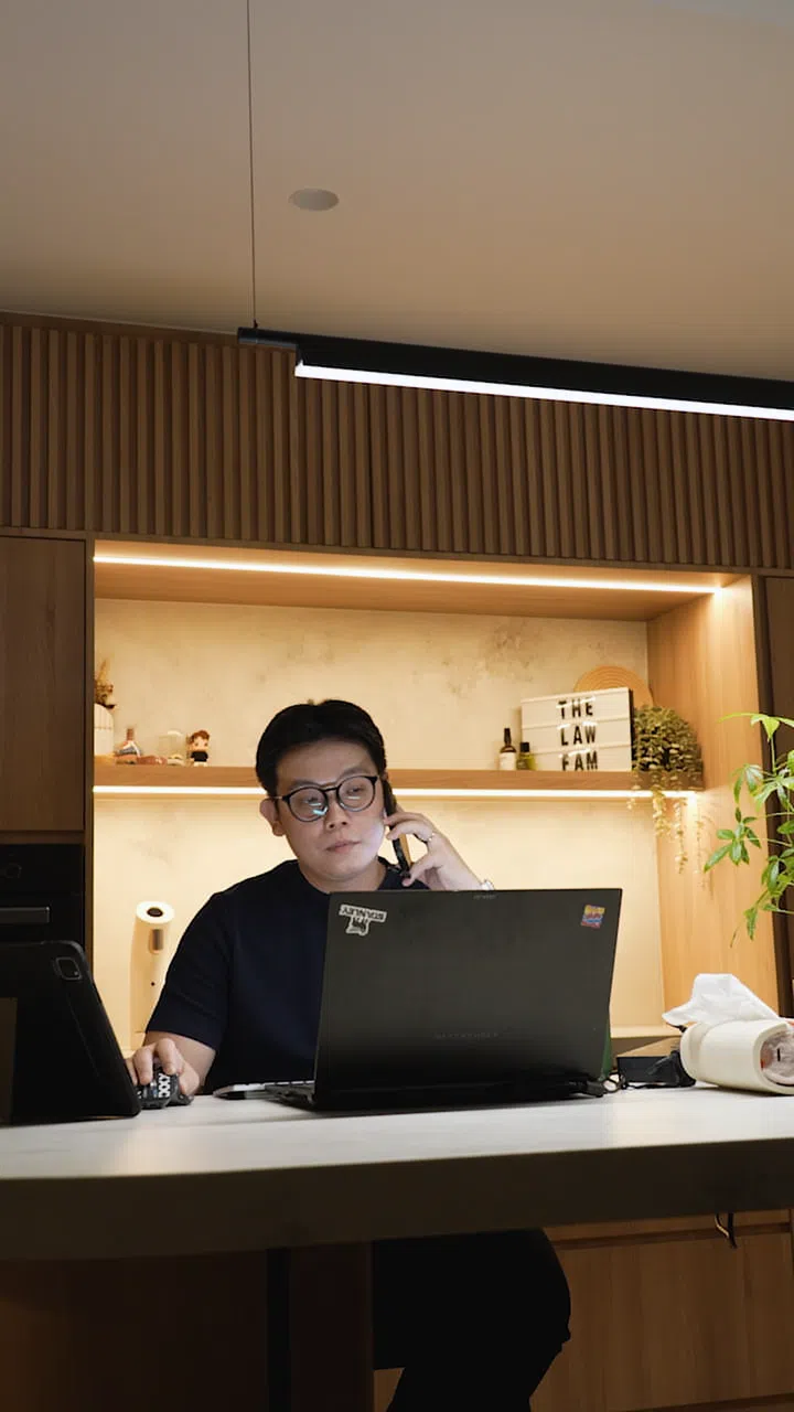 Interior designer Cedrick Law works from the long kitchen island table in his 4-room HDB resale flat in Bedok's dining room.